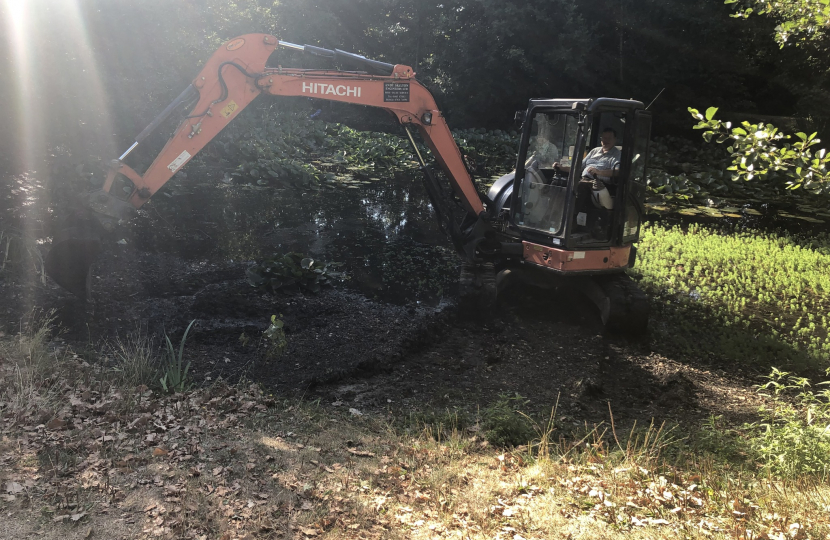 Pictured, the village pond and Cllr John Medhurst clearing the weeds