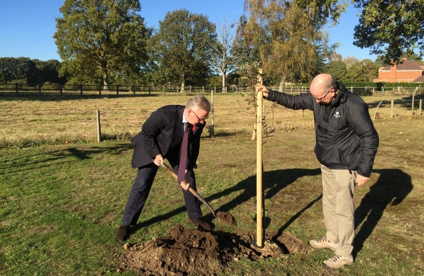 Pictured, Michael planting a row tree as part of the Queen's Commonwealth Canopy