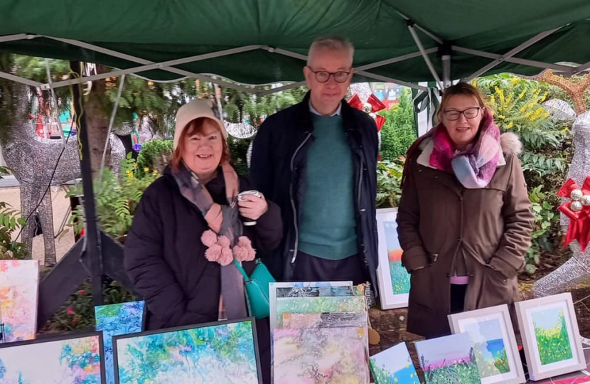 Pictured, Michael Gove with Christmas traders and Parish Cllr Katia Malcaus Cooper