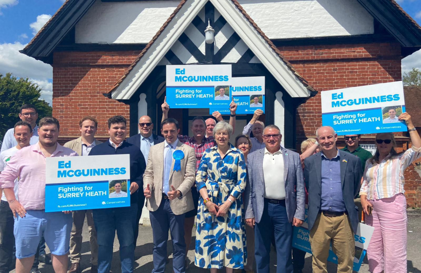 Pictured, Ed McGuinness, Theresa May, and Surrey Heath Conservative Association team members