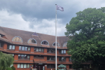 Pictured, the flag raising ceremony at Surrey Heath House