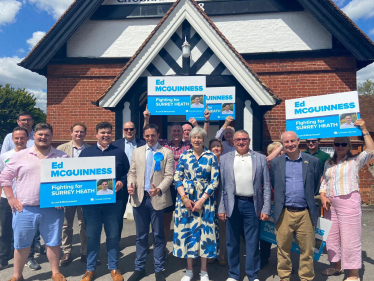 Pictured, Ed McGuinness, Theresa May, and Surrey Heath Conservative Association team members